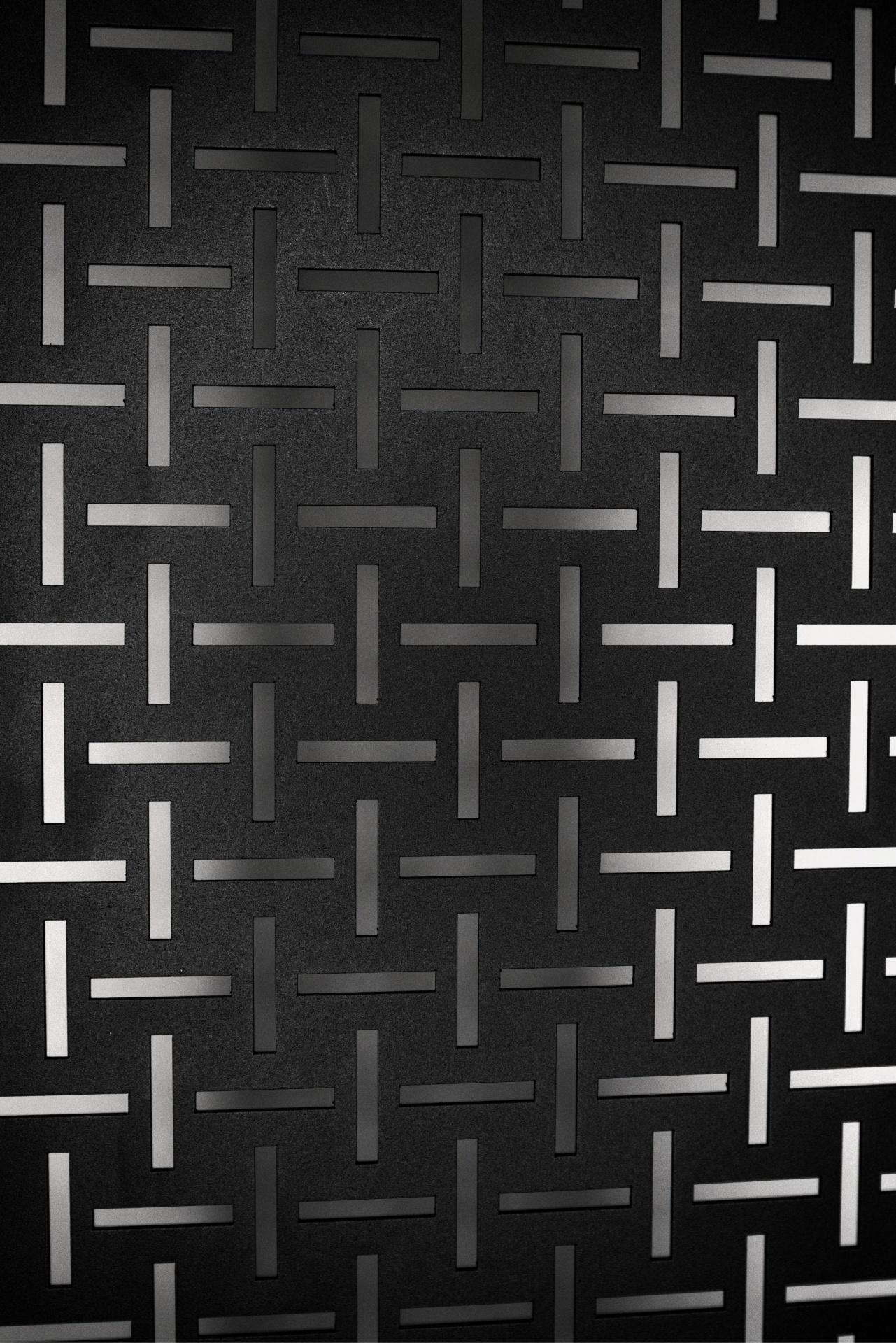 Close-up of the SpartanGrid slot pattern in powder-coated steel